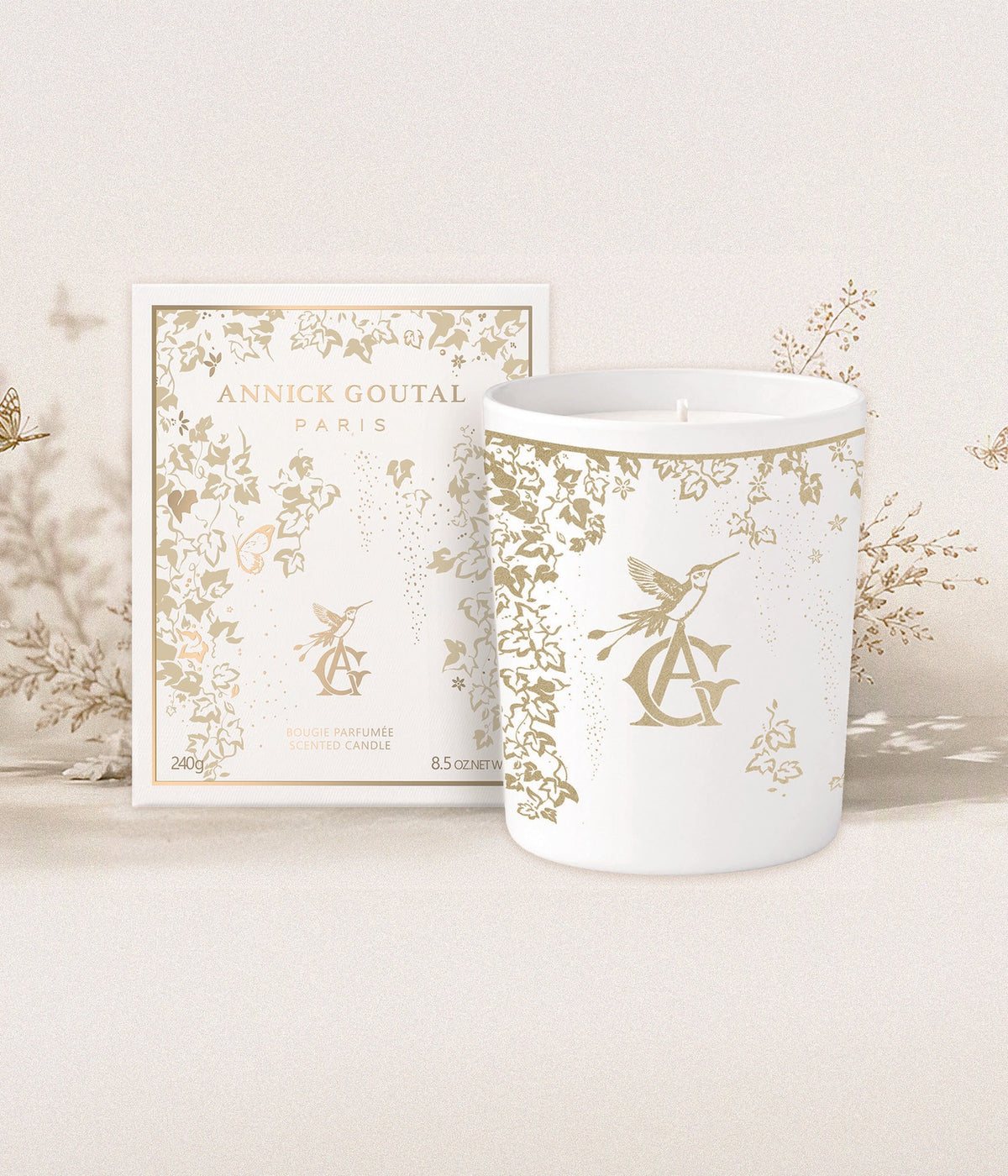 Annick Goutal Scented Candle Noël — Une Forêt d’Or with box in front of golden branches